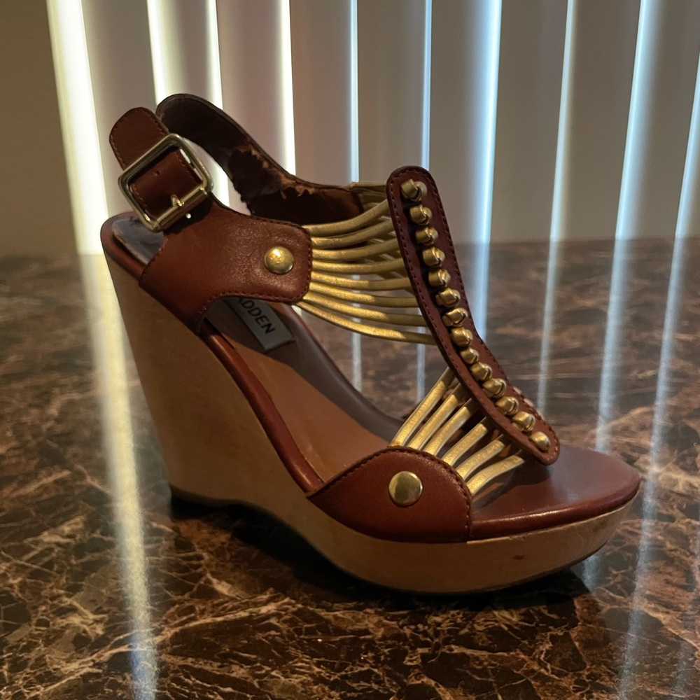 Steve Madden gladiator style leather wedge with gold features.